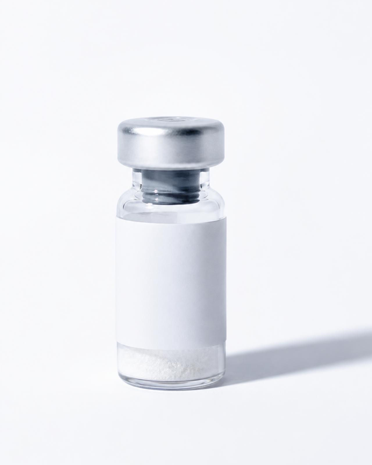 Sealed vial of lyophilized research peptide beside laboratory glassware
